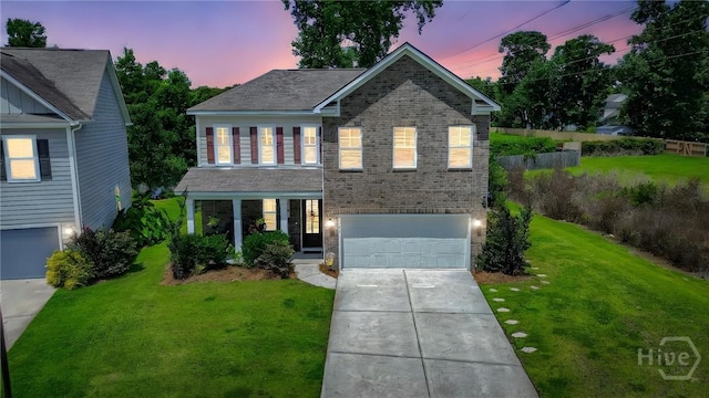 143 Arusha Ave, Savannah, GA 31419 - traditional home featuring a garage, driveway, brick siding, and a lawn