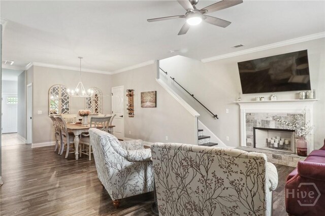18 Sagefield Dr, Ellabell, GA 31308 - living area featuring stairway, crown molding, wood finished floors, a ceiling fan, and a tile fireplace
