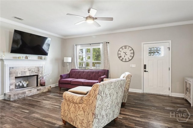 18 Sagefield Dr, Ellabell, GA 31308 - living area with ceiling fan, dark wood-type flooring, crown molding, and a fireplace with raised hearth