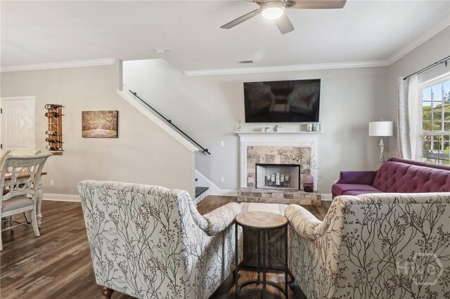 18 Sagefield Dr, Ellabell, GA 31308 - living room with dark wood-style flooring, stairway, ornamental molding, ceiling fan, and a fireplace with raised hearth