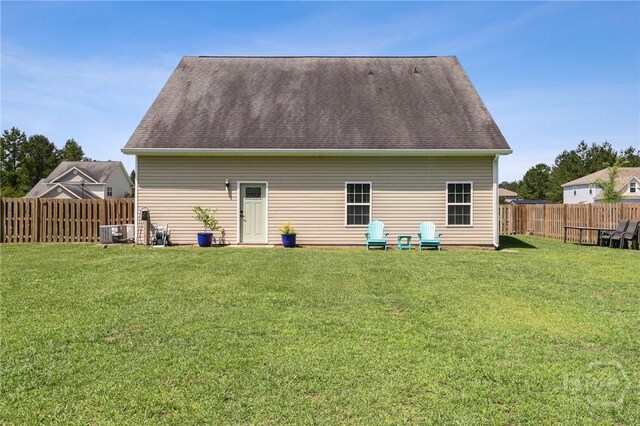 18 Sagefield Dr, Ellabell, GA 31308 - back of property featuring a fenced backyard and roof with shingles