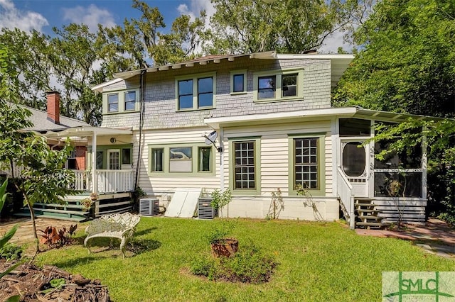 215 E 45th St, Savannah, GA 31405 - view of front of property with a deck, a sunroom, and a front lawn