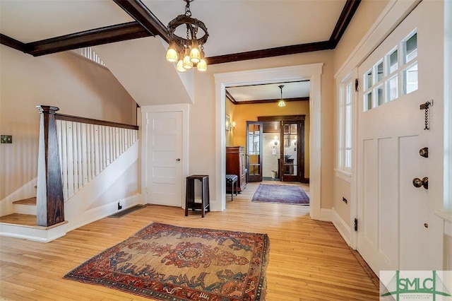 215 E 45th St, Savannah, GA 31405 - foyer with crown molding, light wood-style floors, a chandelier, and stairway