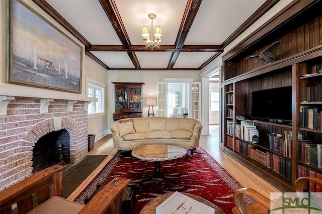 215 E 45th St, Savannah, GA 31405 - living room featuring wood finished floors, coffered ceiling, a chandelier, a fireplace, and beamed ceiling