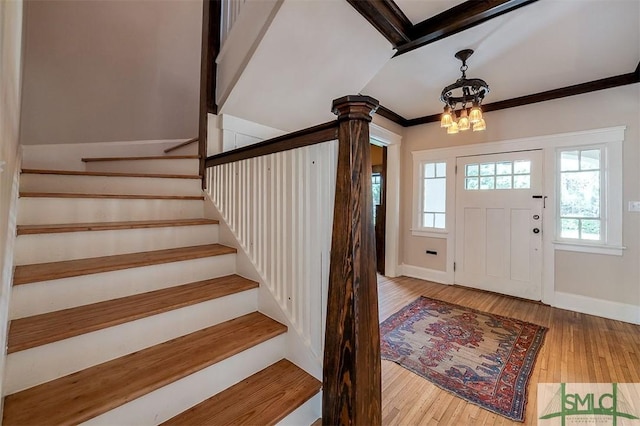 215 E 45th St, Savannah, GA 31405 - foyer featuring wood-type flooring, stairs, a chandelier, and ornamental molding