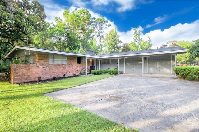 320 Windsor Rd, Savannah, GA 31419 - ranch-style house with a garage, brick siding, a front yard, and concrete driveway
