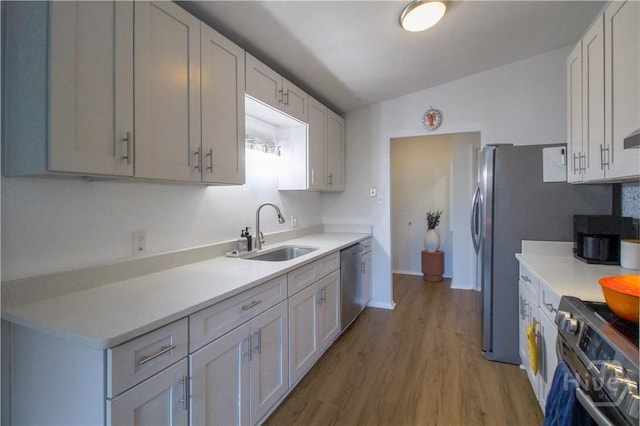 320 Windsor Rd, Savannah, GA 31419 - kitchen with gas range oven, stainless steel dishwasher, wood finished floors, light countertops, and vaulted ceiling