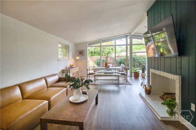 320 Windsor Rd, Savannah, GA 31419 - living room with vaulted ceiling, wood finished floors, and a fireplace
