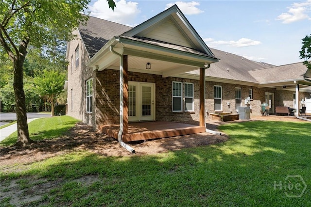 146 Royal Ln, Pooler, GA 31322 - back of house with french doors, a lawn, and brick siding