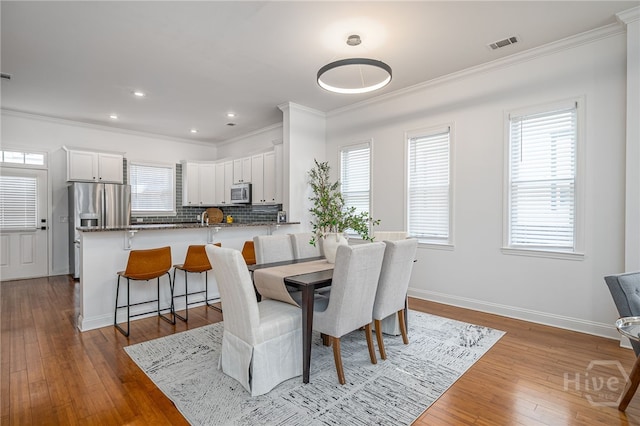 316 E 31st St, Savannah, GA 31401 - dining area with crown molding, hardwood / wood-style floors, and recessed lighting
