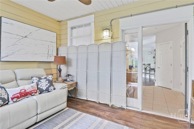 1212 Whitemarsh Way, Savannah, GA 31410 - living room with wooden walls, wood finished floors, and ceiling fan