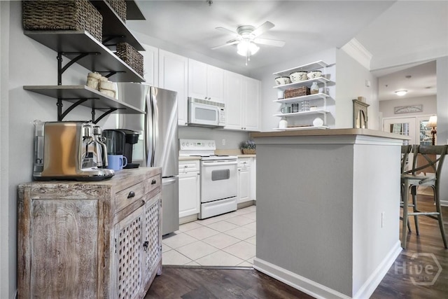 1212 Whitemarsh Way, Savannah, GA 31410 - kitchen featuring open shelves, white appliances, white cabinetry, and ceiling fan