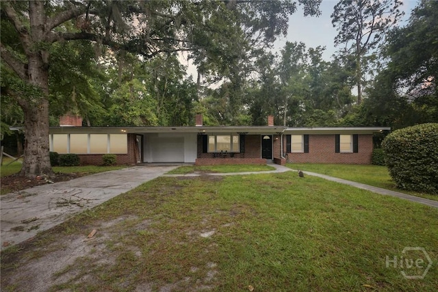 406 E 3rd St, Springfield, GA 31329 - single story home with brick siding, a chimney, concrete driveway, a front lawn, and an attached carport