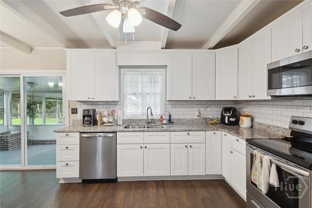 406 E 3rd St, Springfield, GA 31329 - kitchen with appliances with stainless steel finishes, beamed ceiling, dark wood finished floors, and plenty of natural light