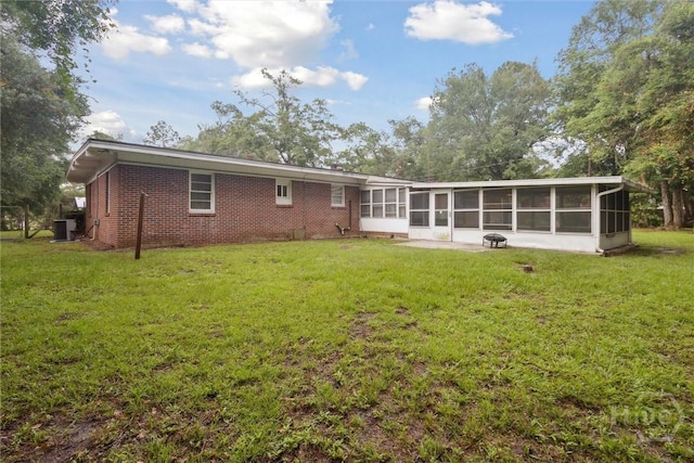 406 E 3rd St, Springfield, GA 31329 - back of house featuring a sunroom, a yard, and brick siding