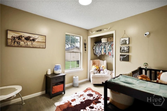 316 Clairemore Cir, Hinesville, GA 31313 - bedroom with a textured ceiling, wood finished floors, and a closet