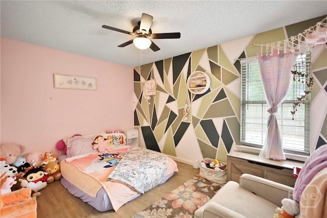 316 Clairemore Cir, Hinesville, GA 31313 - bedroom with multiple windows, a textured ceiling, wood finished floors, and a ceiling fan