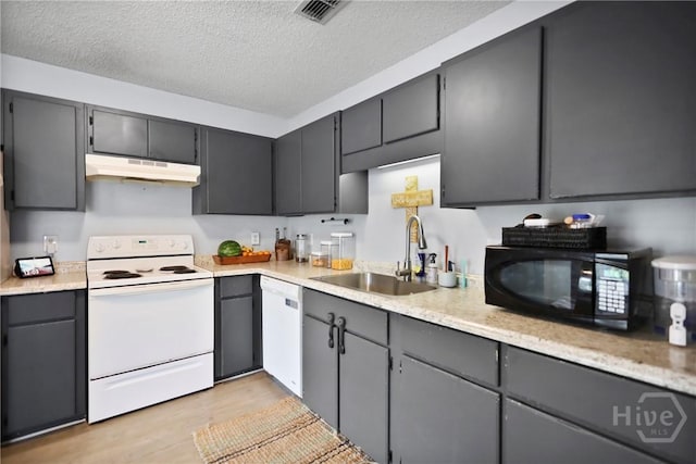 316 Clairemore Cir, Hinesville, GA 31313 - kitchen with white appliances, under cabinet range hood, a textured ceiling, light wood-type flooring, and light countertops