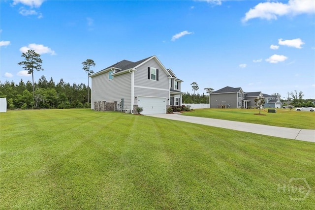 104 Finch Ln, Guyton, GA 31312 - view of side of property featuring an attached garage, concrete driveway, and a yard