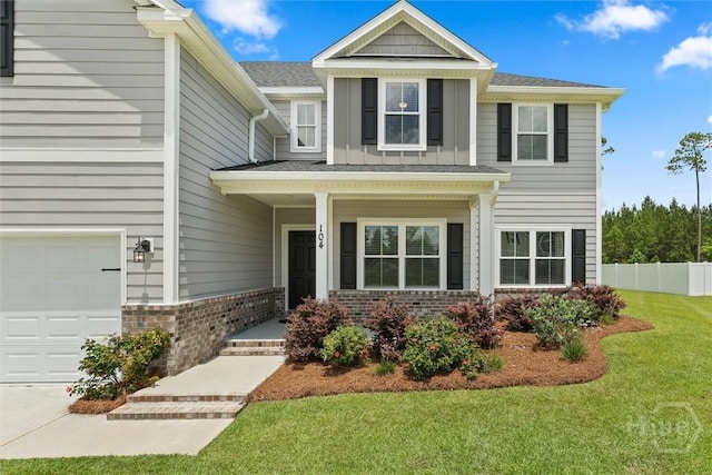 104 Finch Ln, Guyton, GA 31312 - view of front of home with brick siding, an attached garage, and covered porch