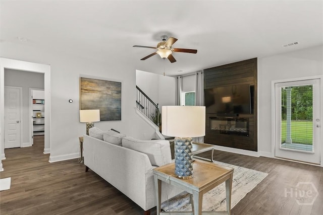 104 Finch Ln, Guyton, GA 31312 - living area with dark wood-type flooring, ceiling fan, and stairs