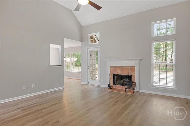 65 Golden Gate Dr, Pooler, GA 31322 - unfurnished living room with high vaulted ceiling, a ceiling fan, a tile fireplace, and wood finished floors