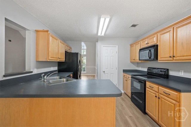 65 Golden Gate Dr, Pooler, GA 31322 - kitchen featuring black appliances, dark countertops, light wood finished floors, light brown cabinets, and a textured ceiling