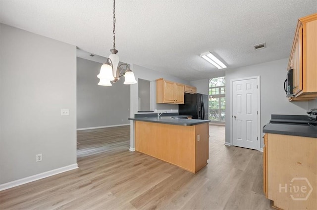 65 Golden Gate Dr, Pooler, GA 31322 - kitchen with black appliances, dark countertops, light brown cabinetry, light wood finished floors, and a peninsula