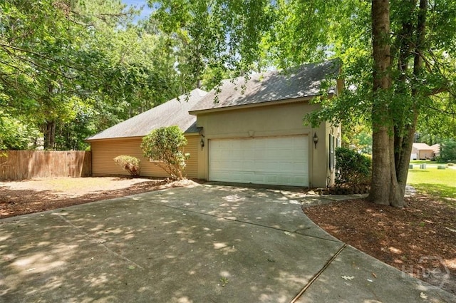 65 Golden Gate Dr, Pooler, GA 31322 - view of side of home with driveway, an attached garage, roof with shingles, and stucco siding