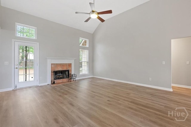 65 Golden Gate Dr, Pooler, GA 31322 - unfurnished living room featuring high vaulted ceiling, plenty of natural light, a tiled fireplace, light wood-style floors, and ceiling fan