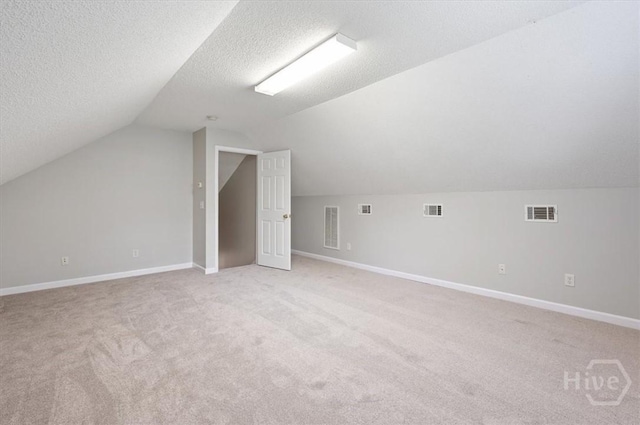 65 Golden Gate Dr, Pooler, GA 31322 - additional living space with light colored carpet, lofted ceiling, and a textured ceiling