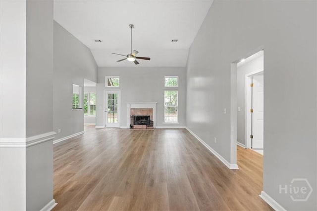 65 Golden Gate Dr, Pooler, GA 31322 - unfurnished living room with ceiling fan, high vaulted ceiling, light wood-type flooring, and a tiled fireplace