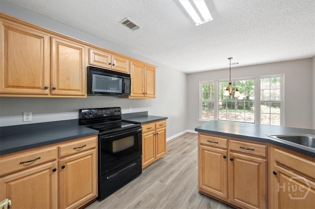 65 Golden Gate Dr, Pooler, GA 31322 - kitchen featuring black appliances, dark countertops, light wood-style flooring, a textured ceiling, and pendant lighting
