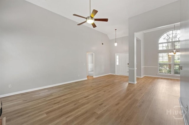 65 Golden Gate Dr, Pooler, GA 31322 - unfurnished living room with high vaulted ceiling, a ceiling fan, wood finished floors, and a chandelier