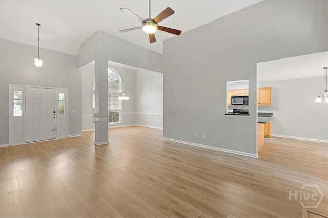 65 Golden Gate Dr, Pooler, GA 31322 - foyer entrance with high vaulted ceiling, ceiling fan, a chandelier, and light wood-style floors