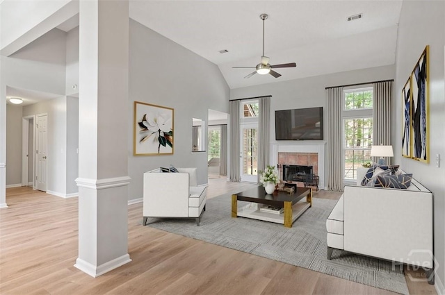 65 Golden Gate Dr, Pooler, GA 31322 - living room with a ceiling fan, light wood finished floors, a tile fireplace, ornate columns, and high vaulted ceiling