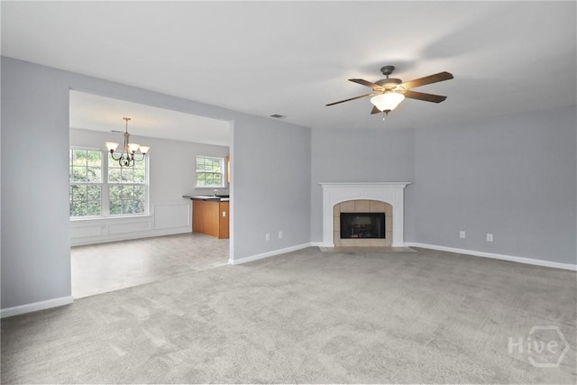 15 Springwater Dr, Port Wentworth, GA 31407 - unfurnished living room featuring a chandelier, light colored carpet, a tiled fireplace, and ceiling fan