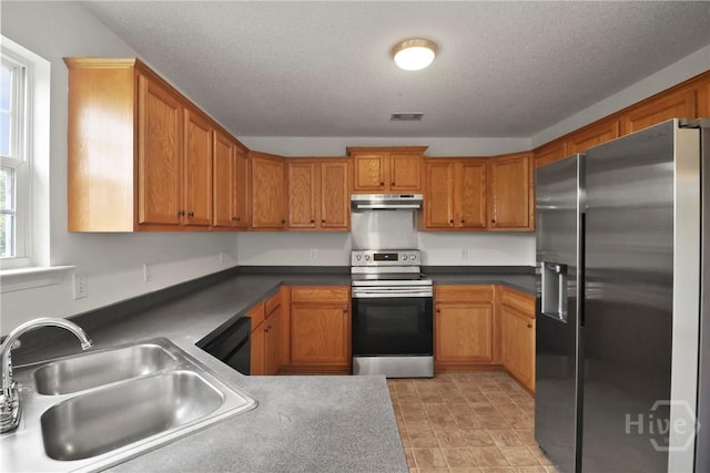 15 Springwater Dr, Port Wentworth, GA 31407 - kitchen with appliances with stainless steel finishes, under cabinet range hood, brown cabinets, and a textured ceiling