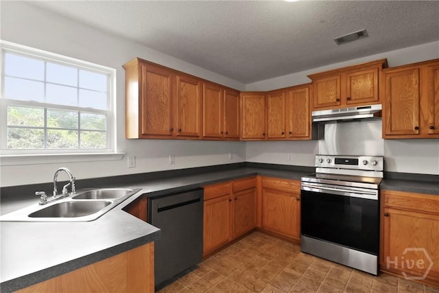 15 Springwater Dr, Port Wentworth, GA 31407 - kitchen featuring stainless steel electric range, dishwashing machine, under cabinet range hood, brown cabinets, and a textured ceiling