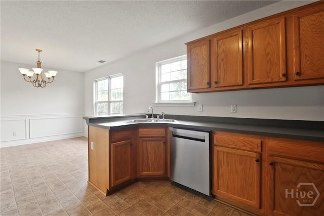15 Springwater Dr, Port Wentworth, GA 31407 - kitchen with stainless steel dishwasher, brown cabinets, dark countertops, a chandelier, and decorative light fixtures