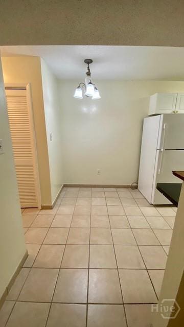 401 N Cromwell Rd Unit G1, Savannah, GA 31410 - unfurnished dining area with light tile patterned floors and baseboards
