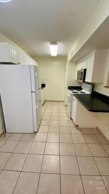 401 N Cromwell Rd Unit G1, Savannah, GA 31410 - kitchen featuring white appliances, light tile patterned floors, and white cabinetry