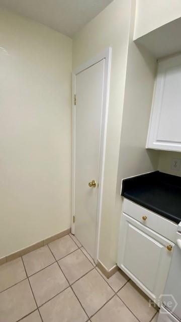 401 N Cromwell Rd Unit G1, Savannah, GA 31410 - washroom with light tile patterned flooring and baseboards