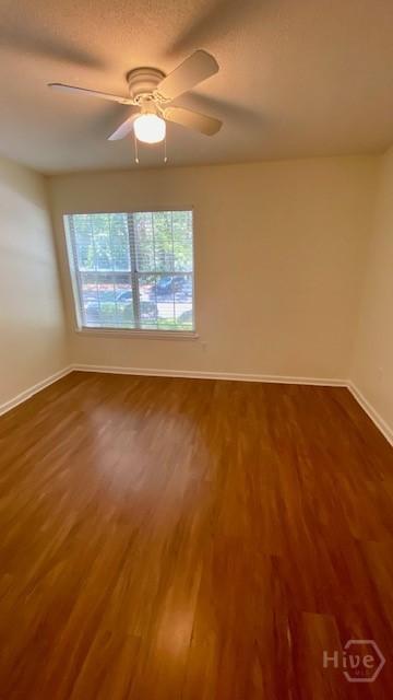 401 N Cromwell Rd Unit G1, Savannah, GA 31410 - spare room featuring dark wood-style floors and a ceiling fan