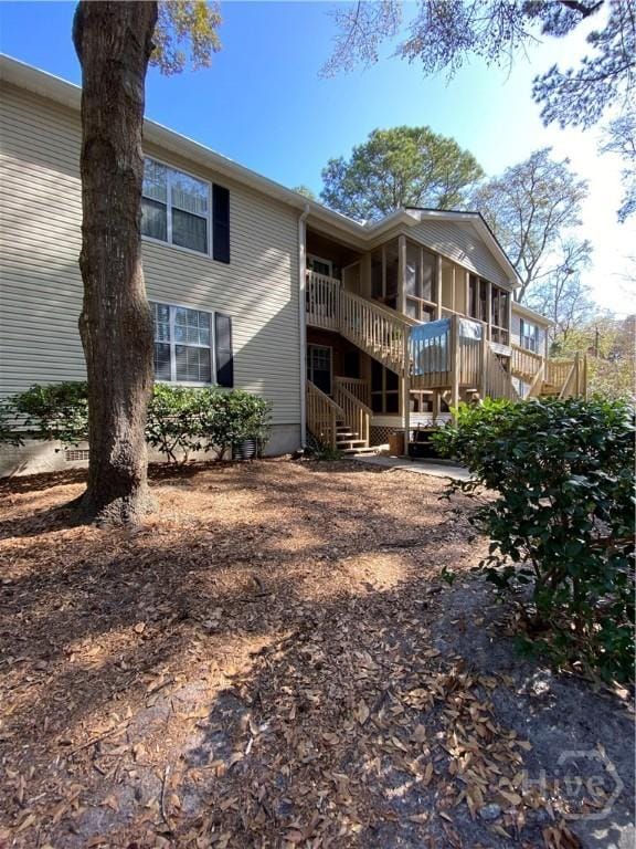 401 N Cromwell Rd Unit G1, Savannah, GA 31410 - back of house featuring a sunroom, stairway, and a wooden deck
