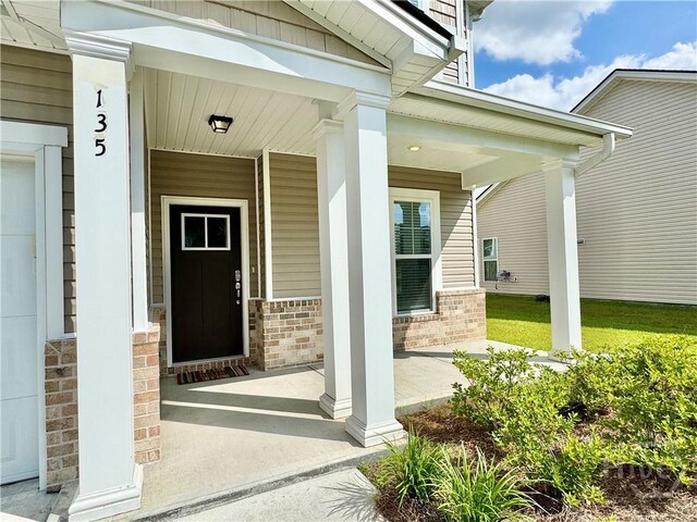 135 Melody Dr, Pooler, GA 31322 - property entrance with a porch and brick siding