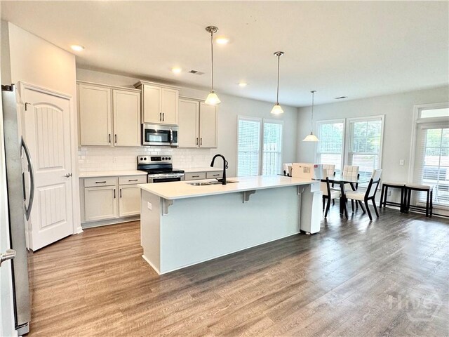 135 Melody Dr, Pooler, GA 31322 - kitchen with appliances with stainless steel finishes, light wood finished floors, light countertops, tasteful backsplash, and recessed lighting