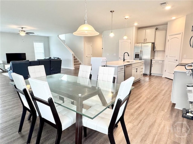 135 Melody Dr, Pooler, GA 31322 - dining area featuring ceiling fan, stairs, and light wood finished floors