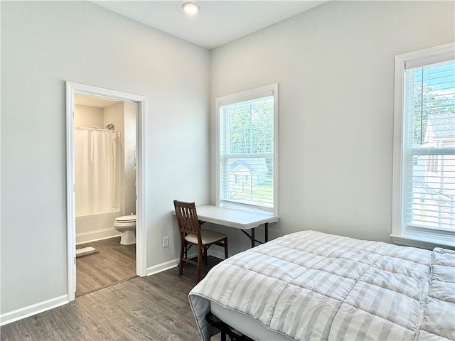 135 Melody Dr, Pooler, GA 31322 - bedroom with wood finished floors, multiple windows, and connected bathroom