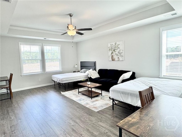 135 Melody Dr, Pooler, GA 31322 - bedroom featuring a tray ceiling, crown molding, hardwood / wood-style floors, multiple windows, and a ceiling fan